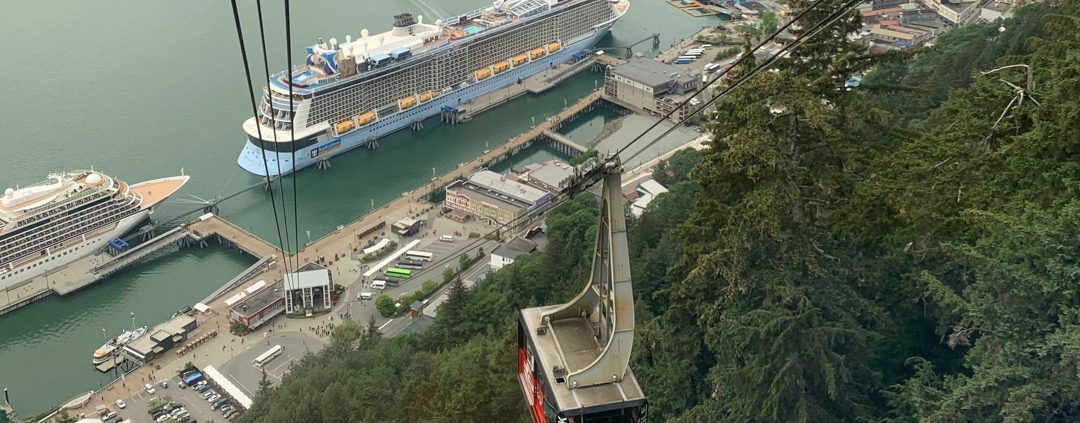 Goldbelt tram car rising above the juneau waterfront including a cruise ship