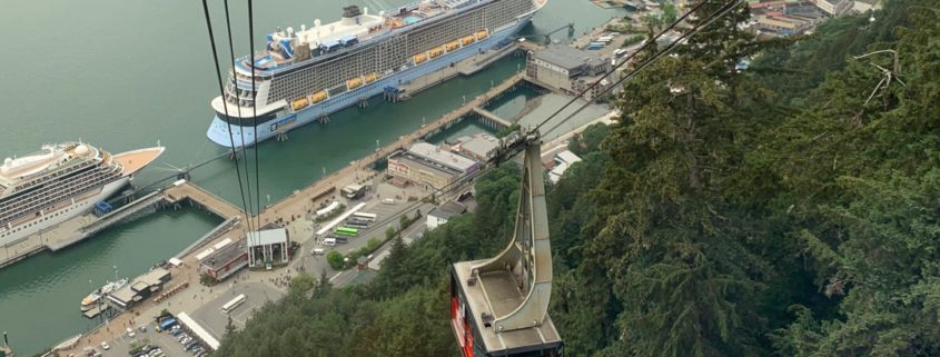 Goldbelt tram car rising above the juneau waterfront including a cruise ship