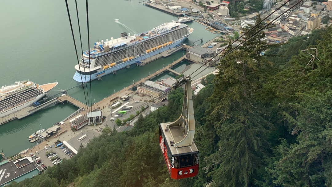 Goldbelt tram car rising above the juneau waterfront including a cruise ship